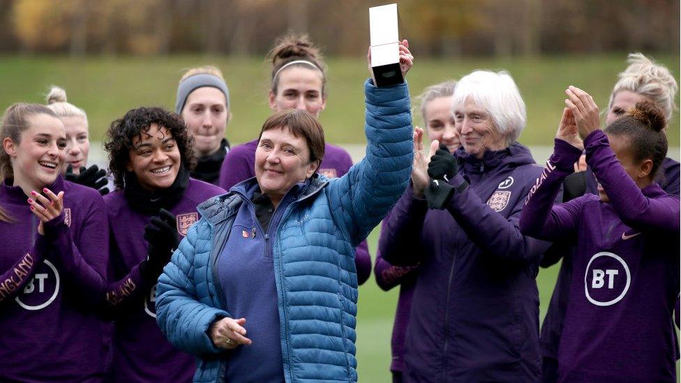 Carol Thomas posed with members of the current England women's team after being inducted into the National Football Museum Hall of Fame in 2021