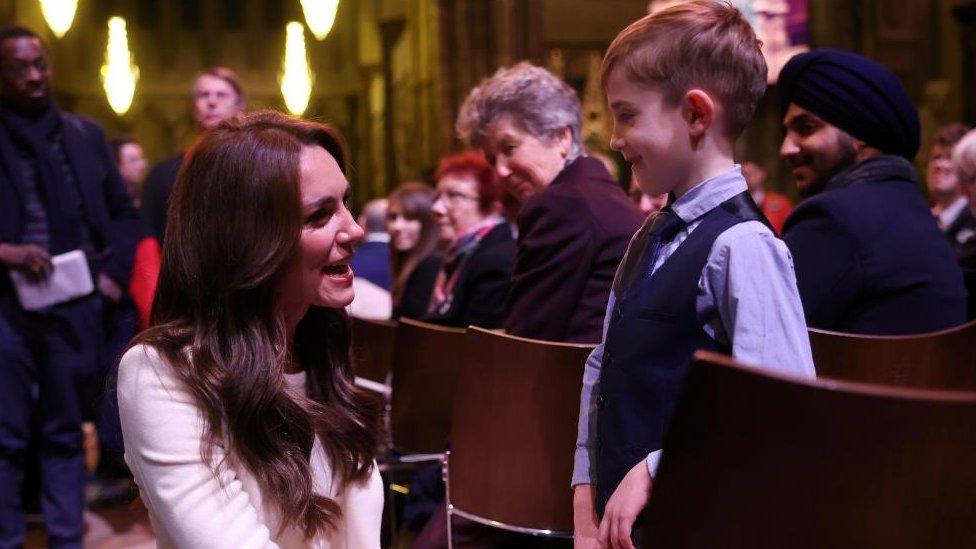 The Princess of Wales chats with a young boy inside Westminster Abbey