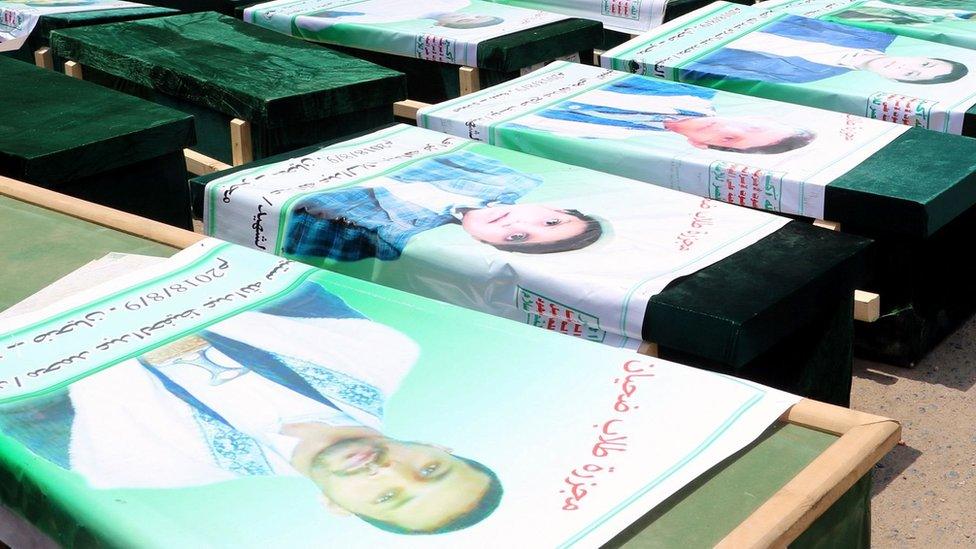 Mourners in Saada city stand next to the coffins of Yemenis killed in a Saudi-led coalition air strike in Dahyan (13 August 2018)