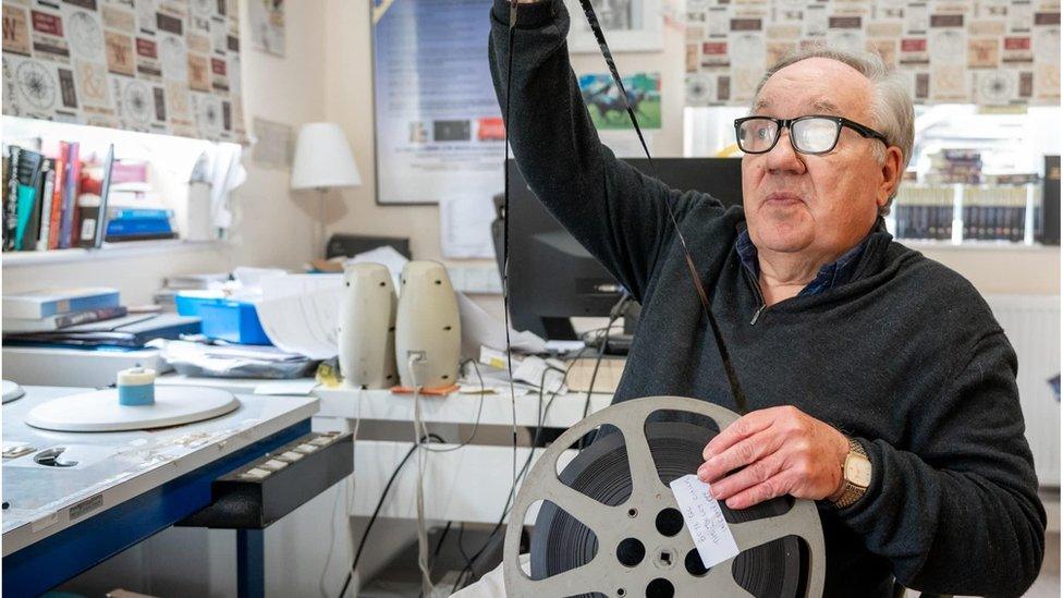 Noel Cronin with a reel of film