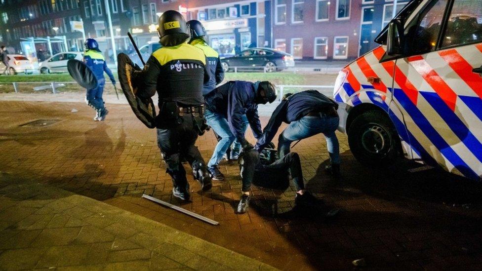 A man is arrested by Police during clashes in Rotterdam, The Netherlands