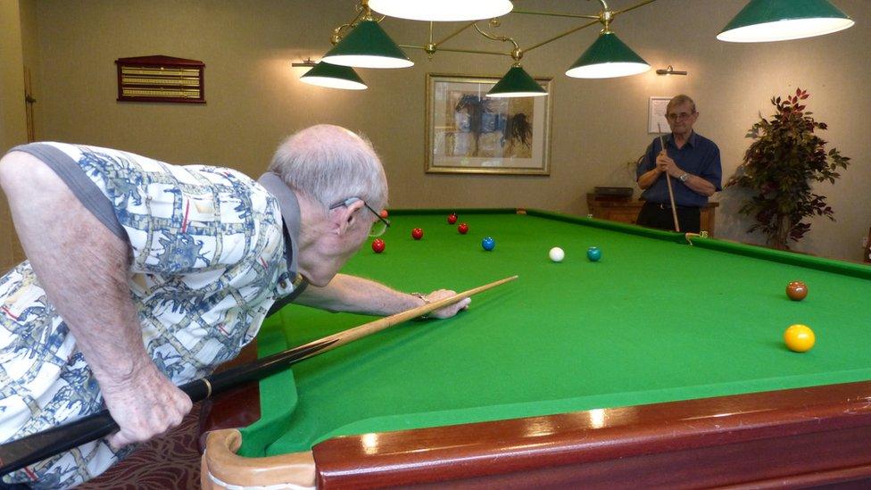 Men playing snooker