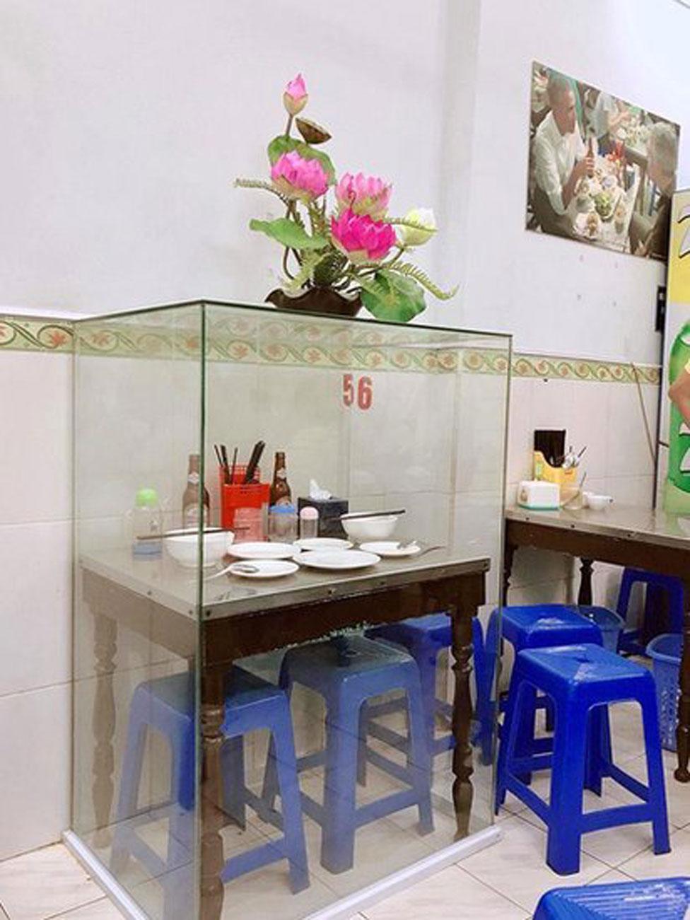 The table where Anthony Bourdain and Barack Obama had their famous meal in Hanoi has been put in a glass case for posterity