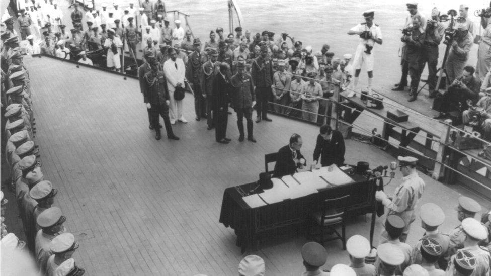 Japanese Foreign Minister Mamoru Shigemitsu signing the Japanese surrender document aboard the USS Missouri