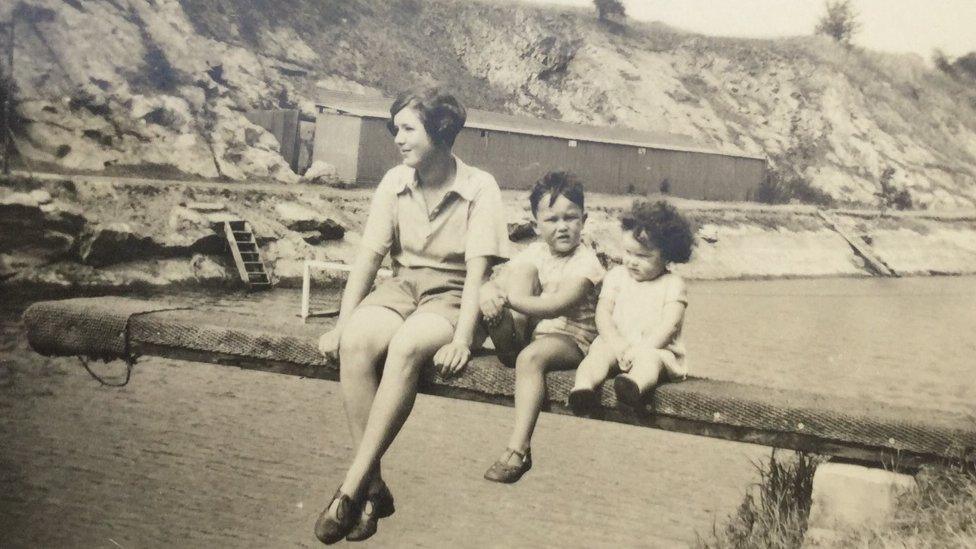 Janet Cocks seated on the far right of the springboard with her older brother and family friend