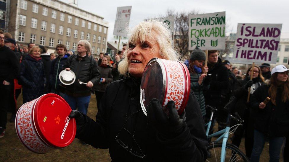 People protest in front of Parliament building in Reykjavik