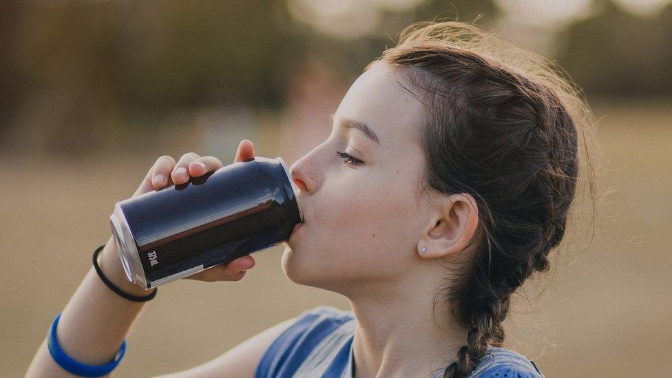 Girl drinking from can