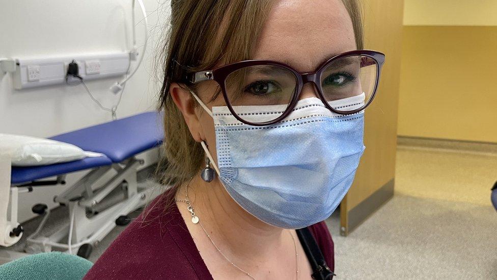 Female GP looks at camera while wearing a mask