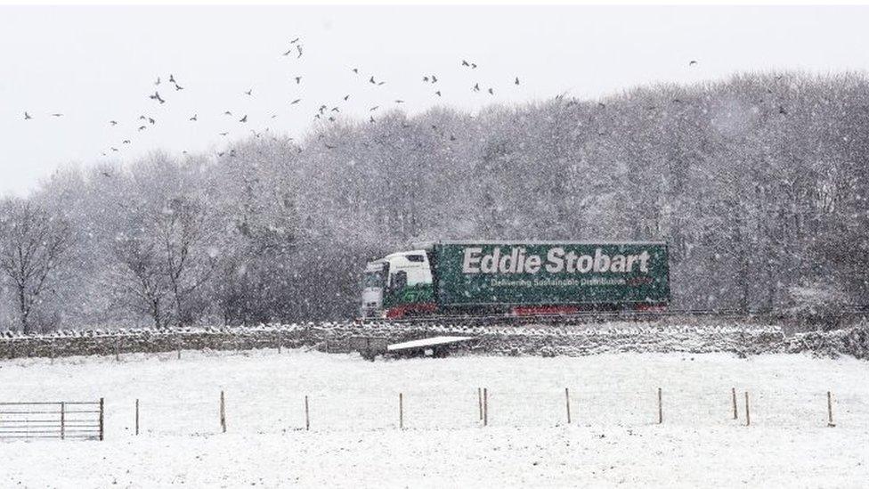 An Eddie Stobart lorry passes through heavy snow on the A66 in the North Pennines