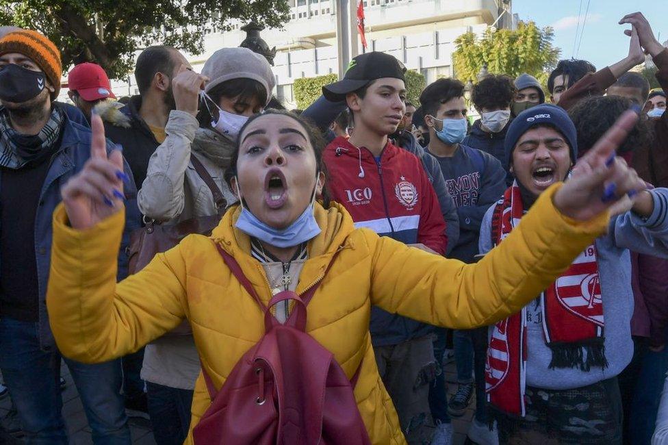 Tunisian protesters shout slogans during an anti-government demonstration on the Habib Bourguiba avenue in the capital Tunis, on January 19, 2021.