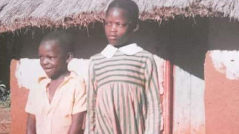 Two young children standing next to each other