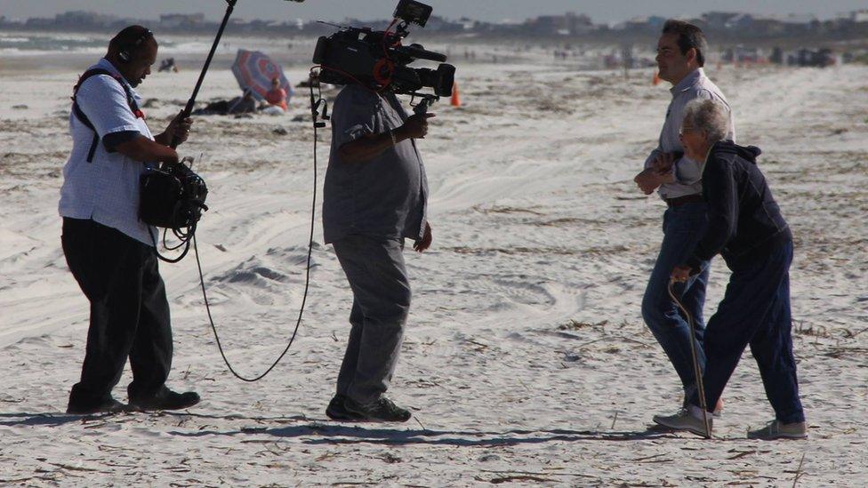 Norma Bauerschmidt and her son Tim with a CBS camera crew