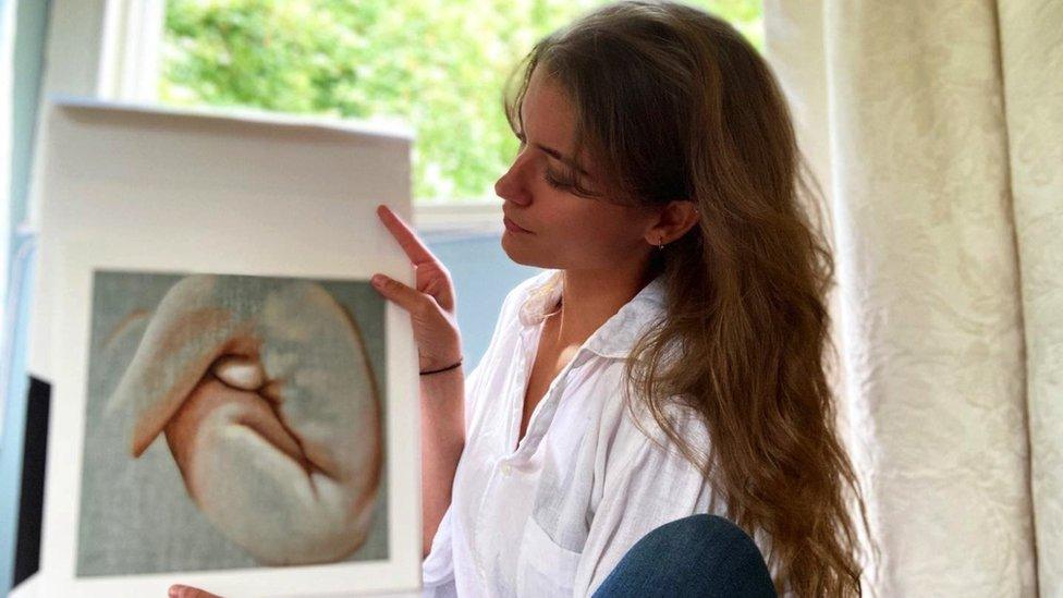 Heloise O'Keeffe holding a painting