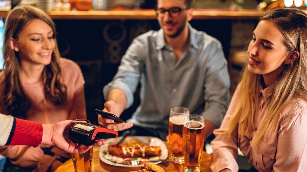 People eating food in a pub