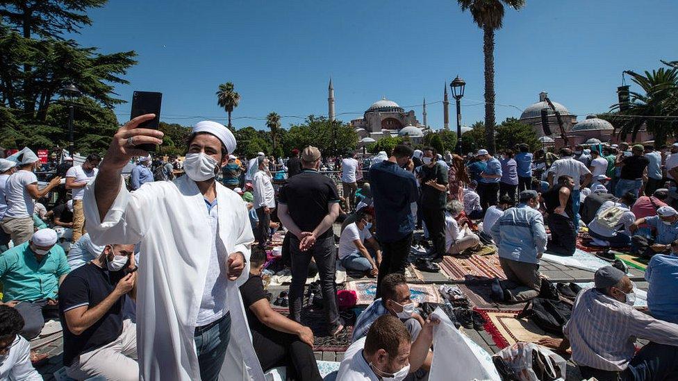 People gather before the first official Friday prayers outside Hagia Sophia Mosque on July 24, 2020 in Istanbul, Turkey