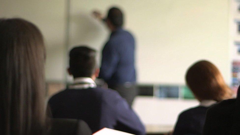 Teacher writing on white board