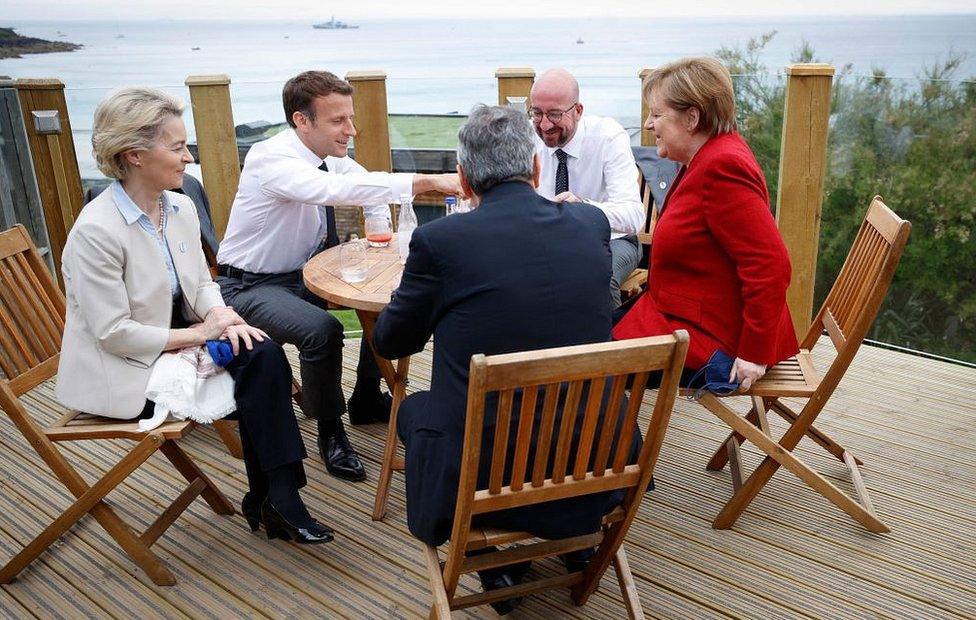 Leaders having a drink by the sea