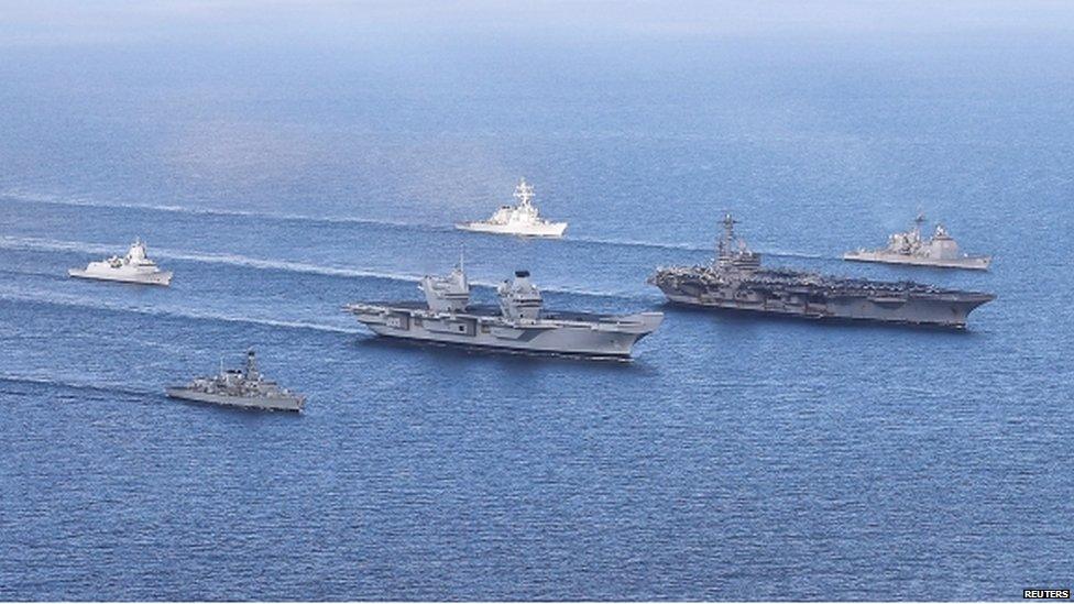 HMS Queen Elizabeth, which is undergoing sea trials, sails with the USS George HW Bush and her carrier strike group, during Exercise Saxon Warrior, off the coast of Scotland