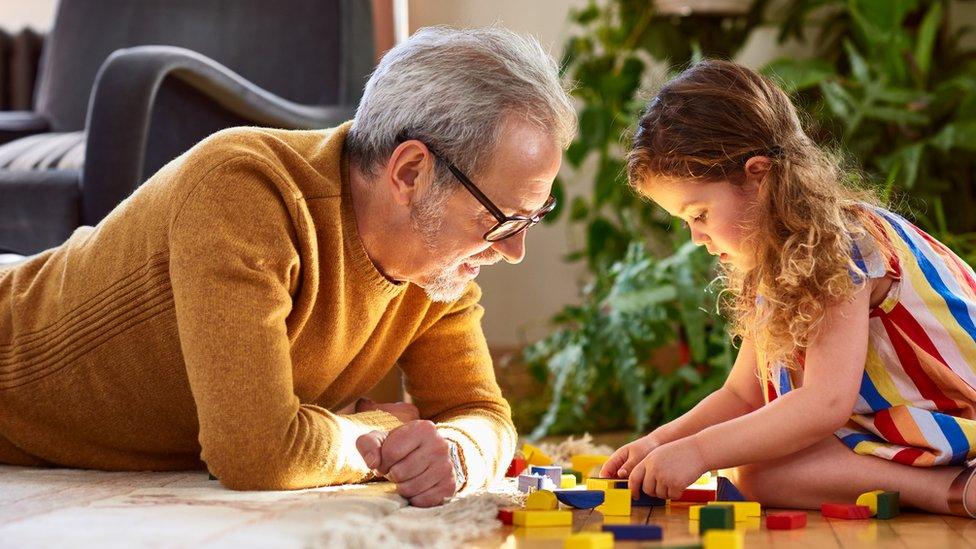 girl-and-granddad-playing-with-lego