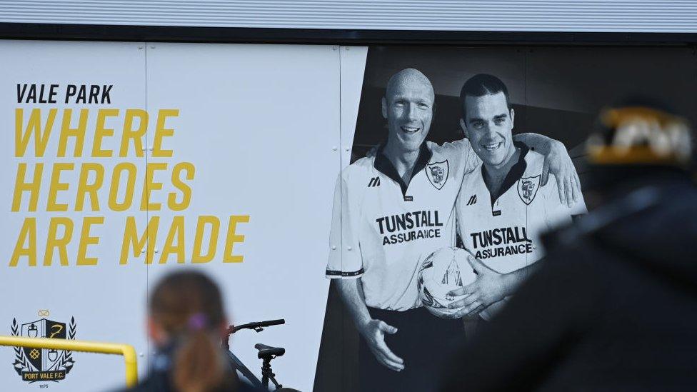 Signage displaying Former Footballer and Manager, Neil Aspin and Robbie Williams