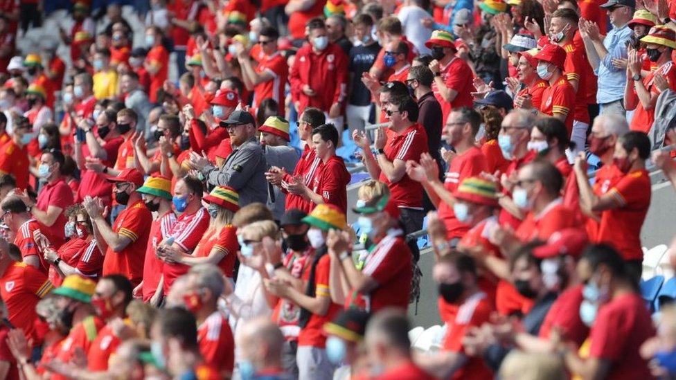 Wales fans cheer in the crowd during the international friendly football match between Wales and Albania at Cardiff City Stadium in Cardiff, South Wales, on June 5, 2021. (Photo by Geoff Caddick / AFP) (Photo by GEOFF CADDICK/AFP via Getty Images)