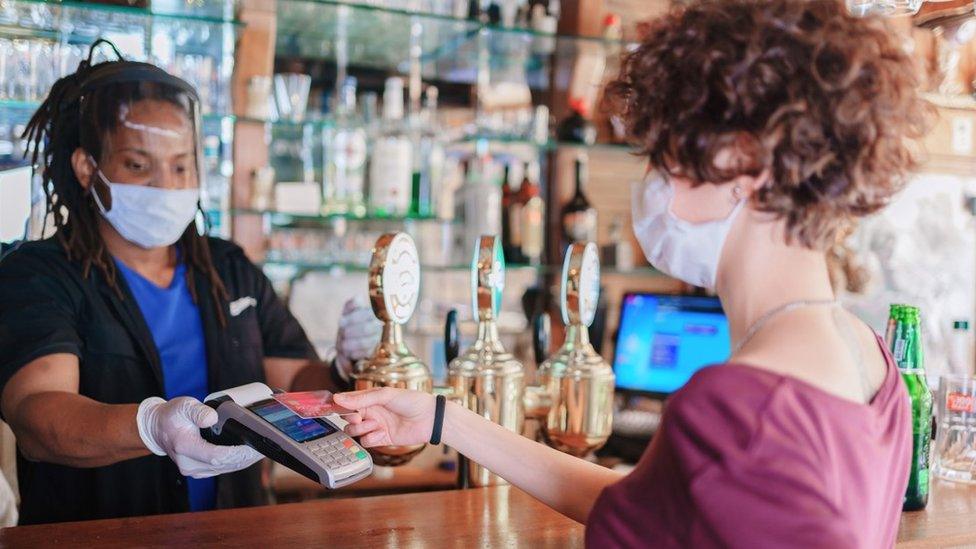 Man serving woman at the bar - generic