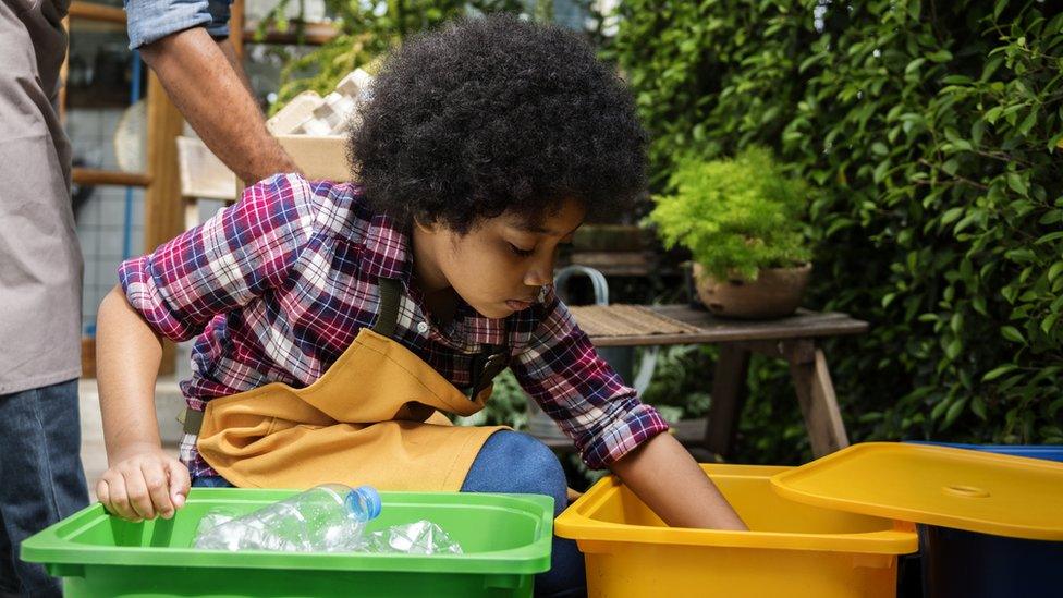 Boy sorting out recycling