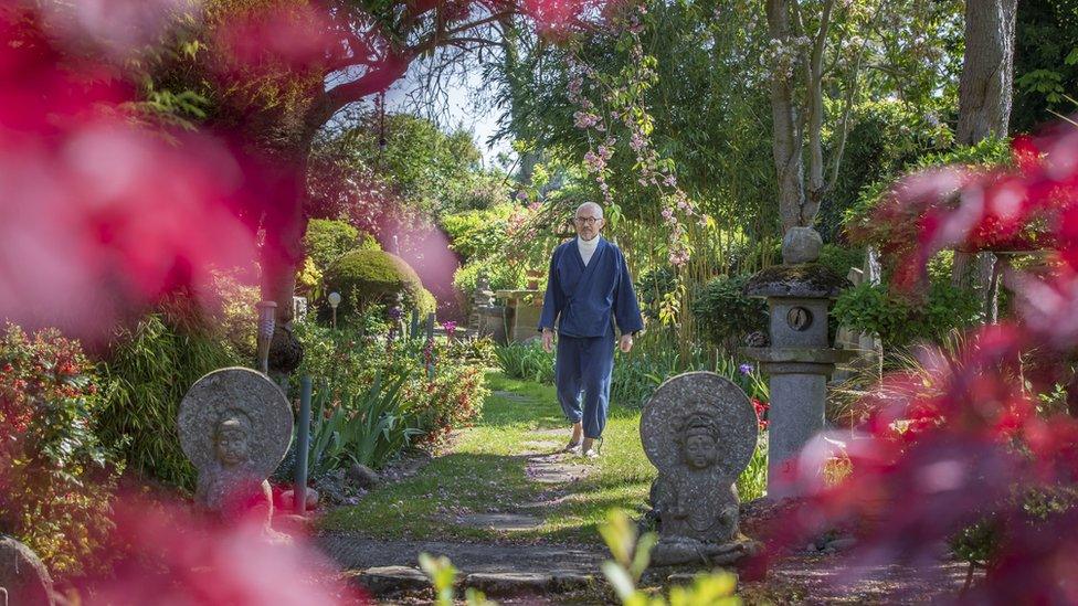 Buddha Maitreya walking through his garden