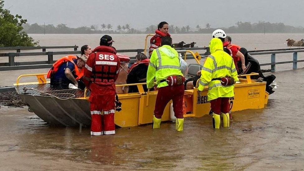 Service personnel evacuating people from flood waters in far north Queensland, Australia