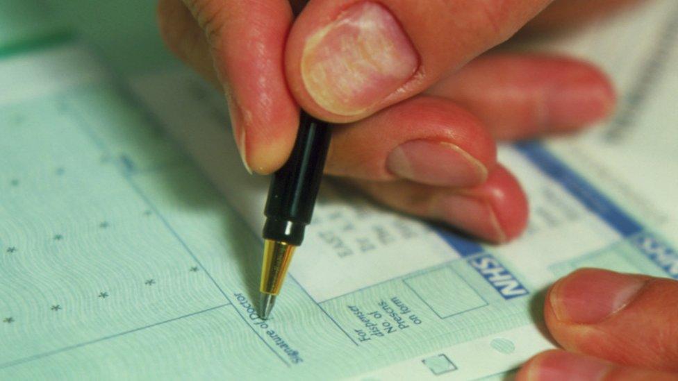 A close-up shot of a doctor writing a prescription