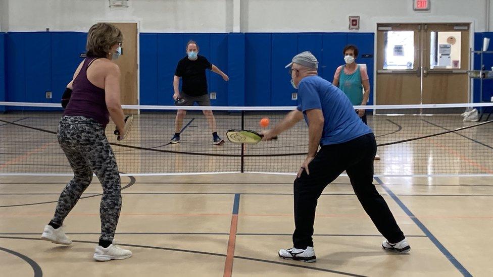 Barbara Gulino and Len Gulino play pickleball with a second couple