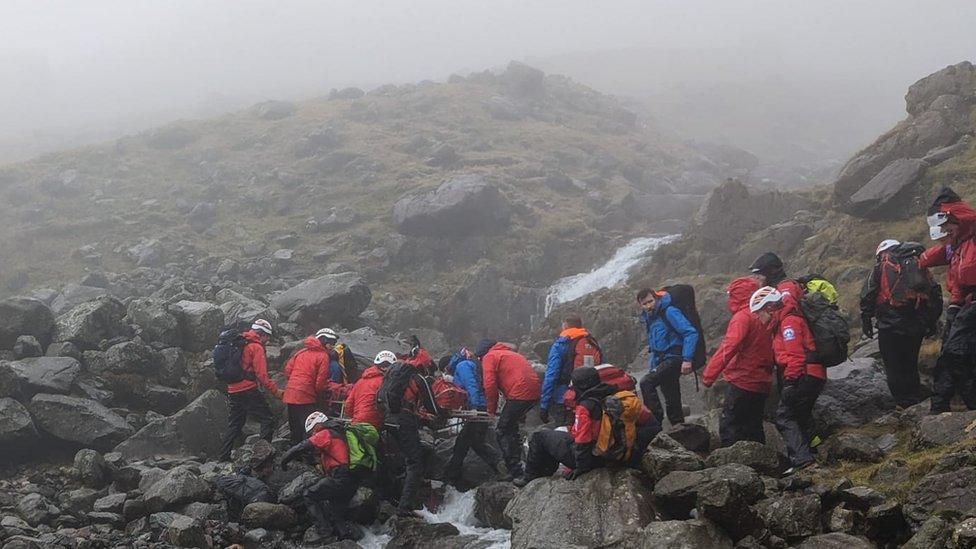 Rescuers help the casualty who was found on the east bank of Piers Gill