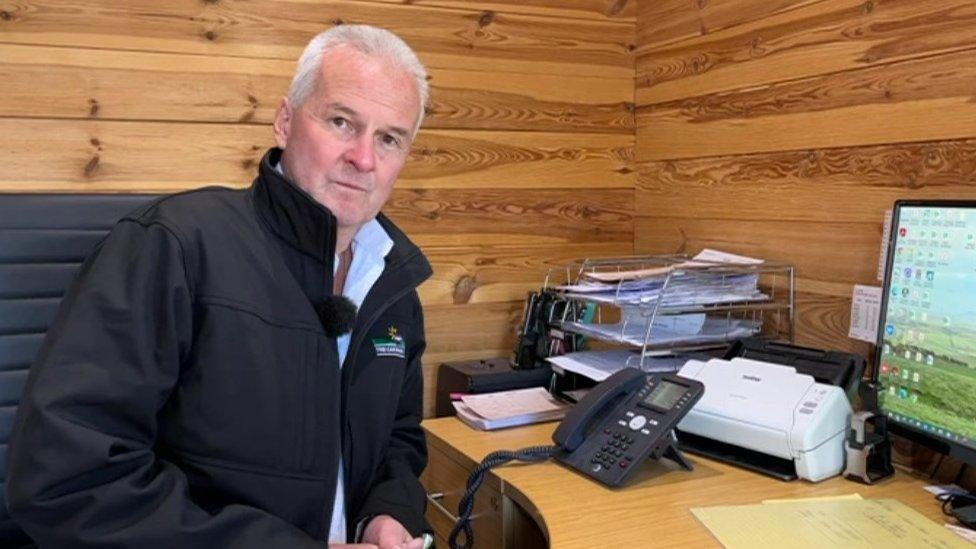 Paul Clark sitting at his desk