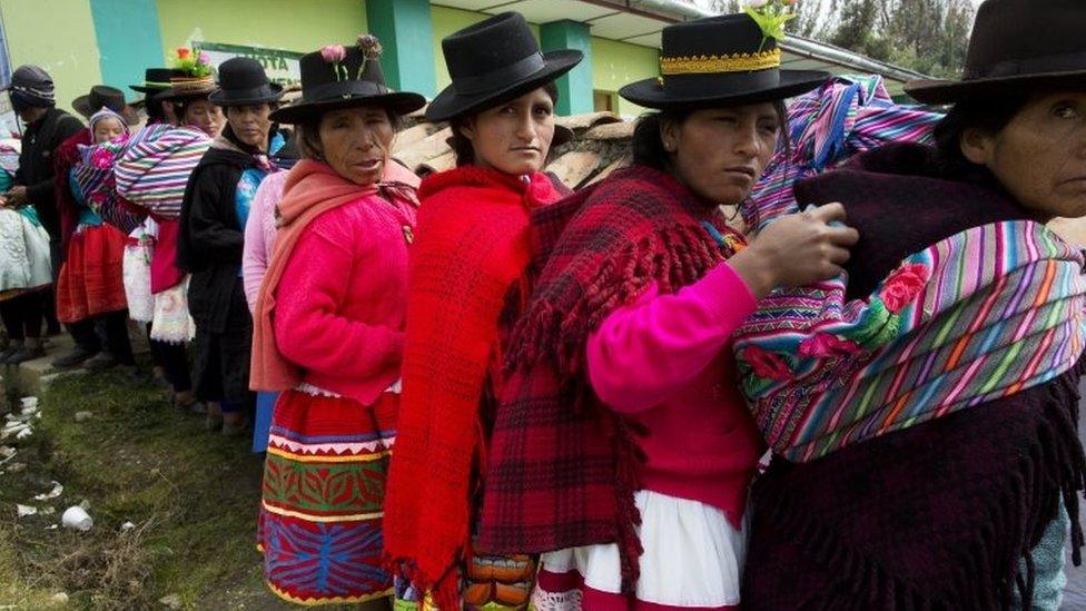 Quechua Indian women stand in line to vote in the general elections, in Uchuraccay, Peru, Sunday, April 10, 2016.