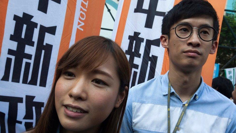 Legislative Councillors-elect Yau Wai-ching (L) and Sixtus Leung (R) are seen as thousands of people march through the streets of Hong Kong to protest against the Legislative Council oath-taking interpretation of the city"s Basic Law, or mini-constitution, by the Chinese authorities in Beijing, Hong Kong, China, 6 November 2016