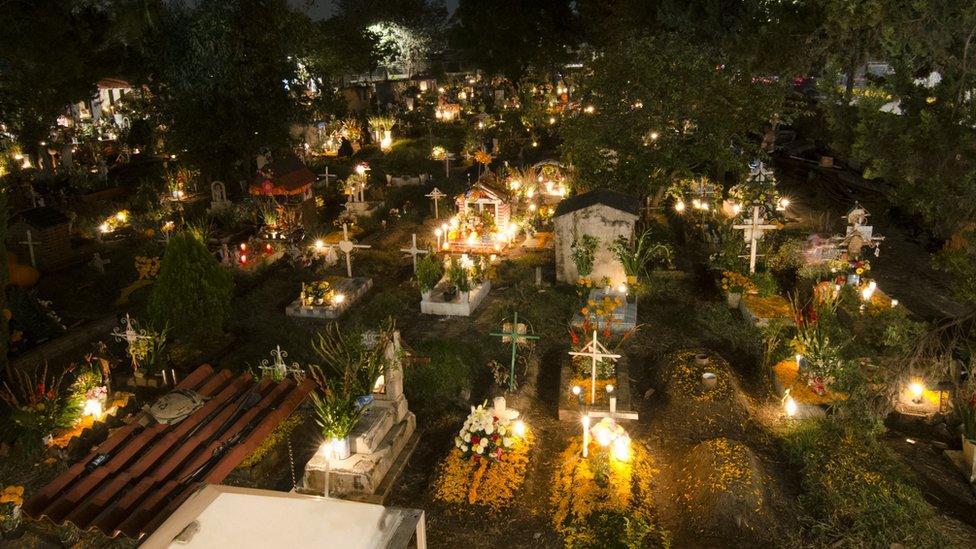 Mexican cemetery lit with candles