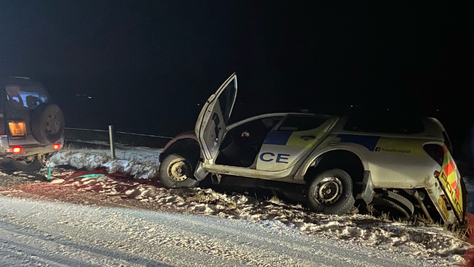 police car in ditch