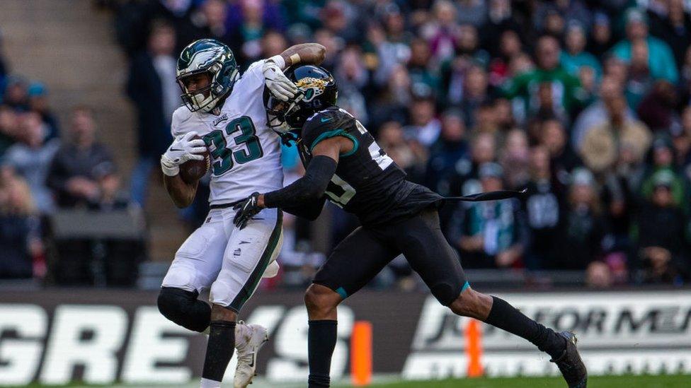 Jalen Ramsey of the Jacksonville Jaguars tackles Josh Adams of the Philadelphia Eagles