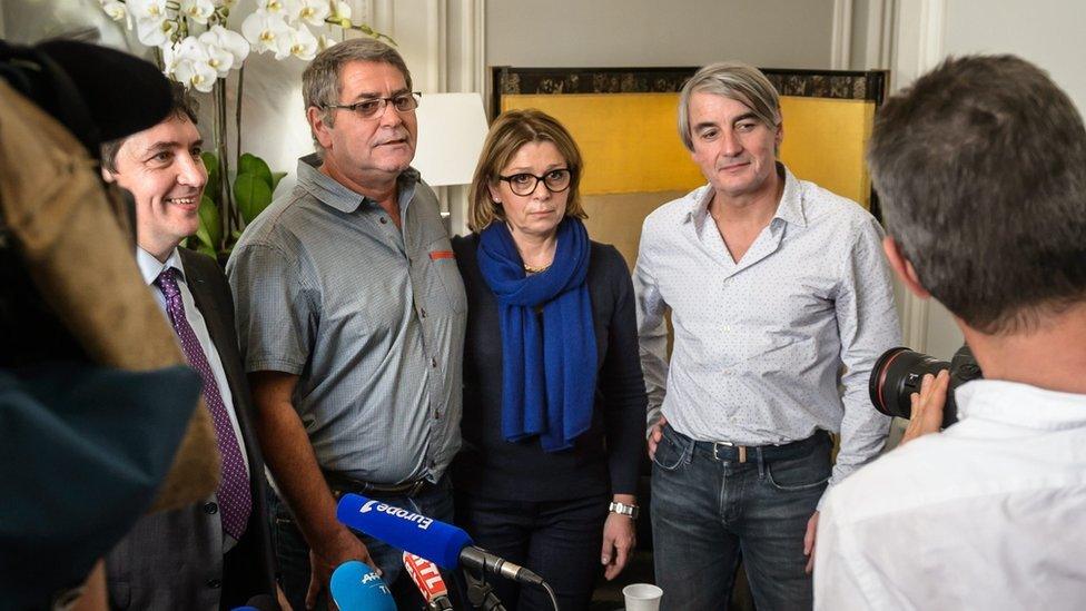 Pascal Fauret, accompanied by his wife and other supporters, addresses journalists in Paris