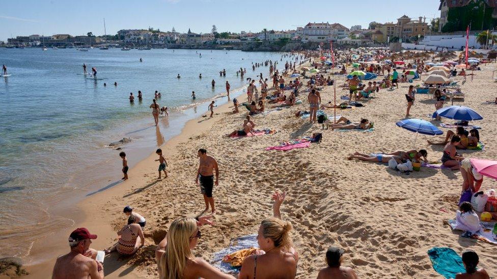 Beachgoers in Cascais, Portugal last summer