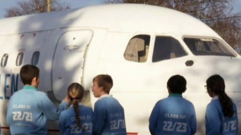 Pupils looking at the plane