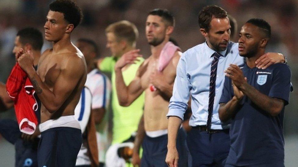 Gareth Southgate walks off the pitch with England players