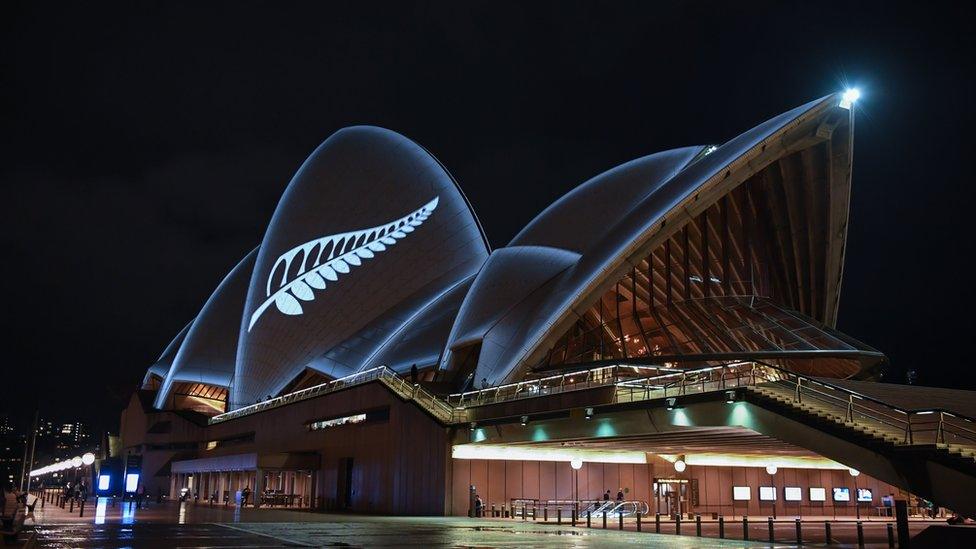 A silver fern is projected onto the sails of the Opera House in commemoration of the victims of the Christchurch massacre on March 16, 2019