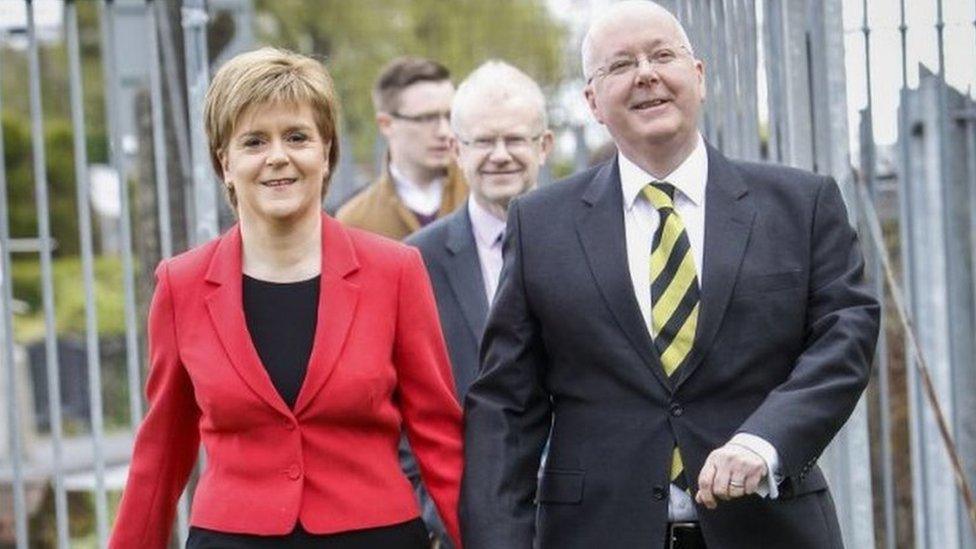 Nicola Sturgeon arrives at a polling station with her husband Peter Murrell