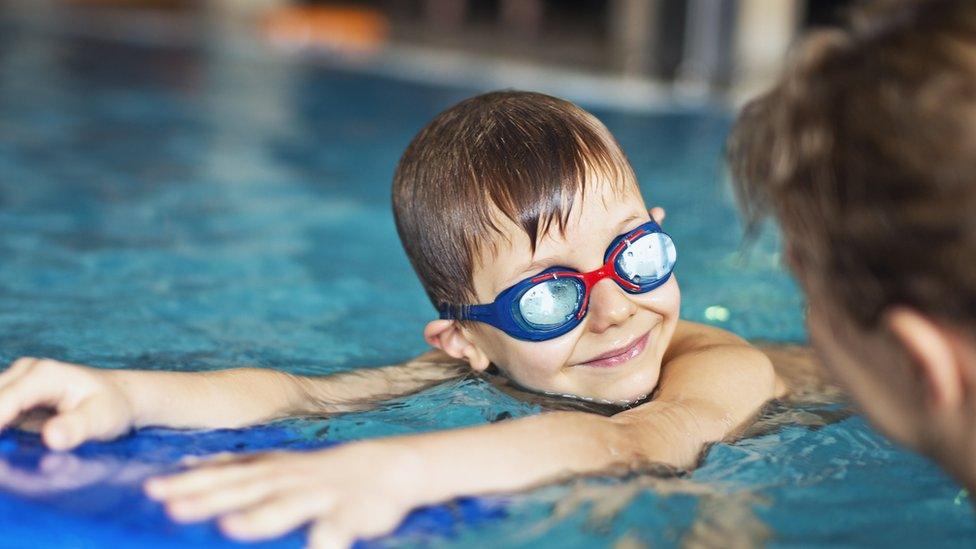 Mother and child using a swimming pool