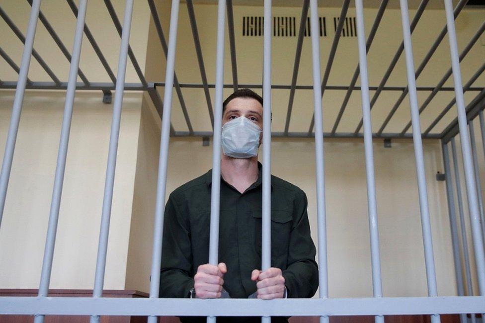 Trevor Reed stands inside a defendants' cage during a court hearing in Moscow, Russia, on 30 July 2020