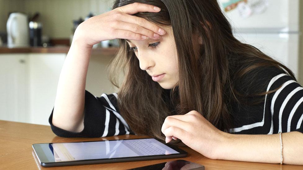 Stock image of a girl working at home