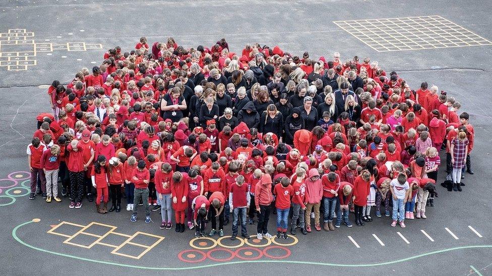 West Ewell Primary School in Surrey gathered in the shape of a poppy to mark the WW1 centenary.