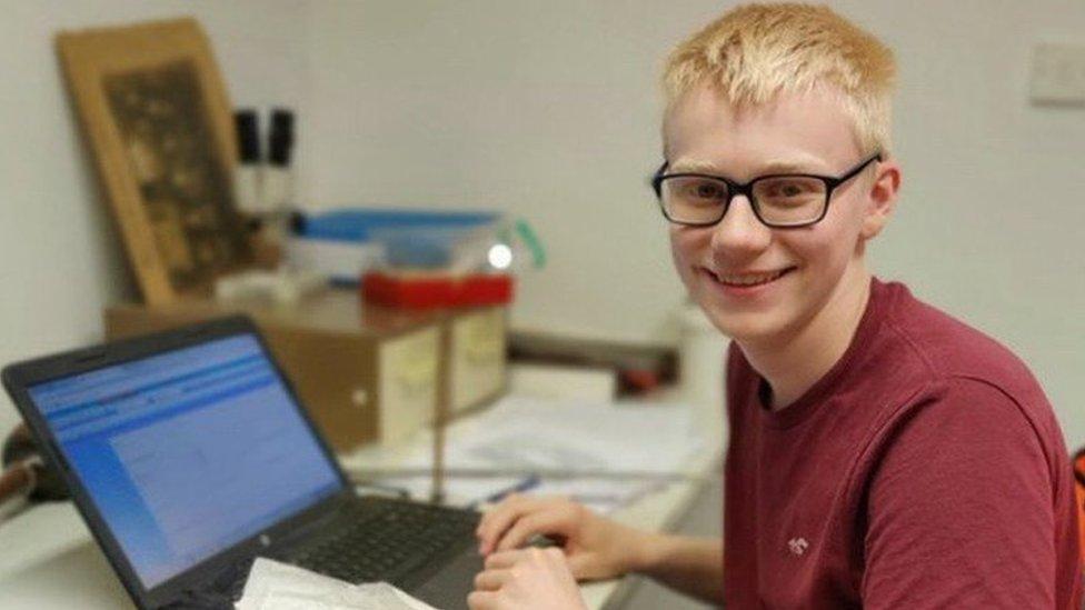 James Douglas sitting at his desk with his laptop