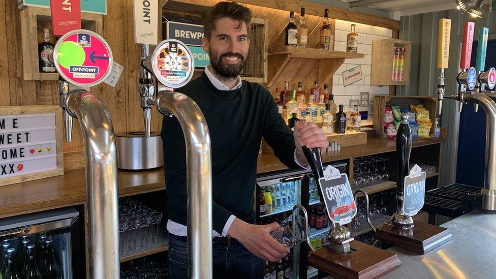 man pulling a pint